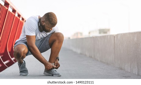 Black Man Tying Running Shoes On Bridge, Free Space