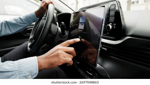 Black Man Using Touchscreen Infotainment Panel In Modern Car Interior.