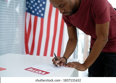 Black man voting in election ballot place
