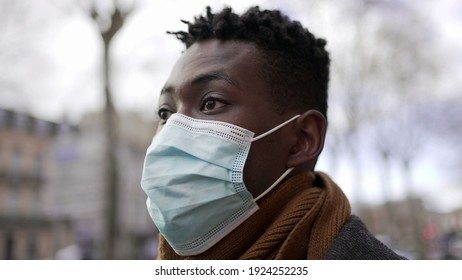 Black Man Walking Outside During Pandemic Wearing Surgical Mask