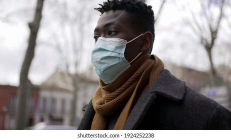 Black Man Walking Outside During Pandemic Wearing Surgical Mask