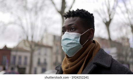 Black Man Walking Outside During Pandemic Wearing Surgical Mask