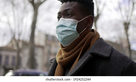 Black Man Walking Outside During Pandemic Wearing Surgical Mask