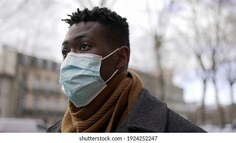 Black Man Walking Outside During Pandemic Wearing Surgical Mask