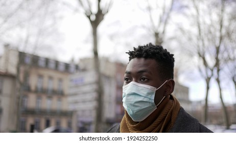 Black Man Walking Outside During Pandemic Wearing Surgical Mask