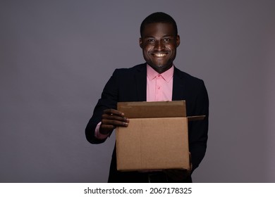 Black Man Wearing A Suit Opening A Box