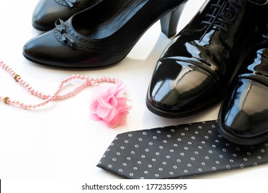 Black Man And Woman Patent Leather Shoes With Pearl Necklace On White Background. Divorce. Wedding. Honeymoon.