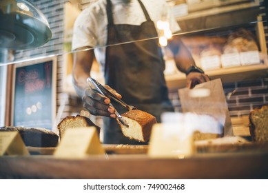 Black man works in pastry shop. - Shutterstock ID 749002468