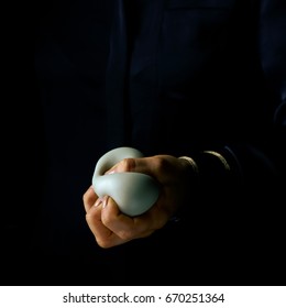 Black Mania. Woman Hand Isolated On Black Using Anti Stress Ball