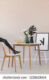 Black Mannequin's Leg On Wooden Chair In Elegant Dining Room Interior With Copy Space On The Empty Wall