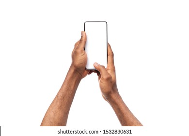 Black man's hands holding mobile phone with blank screen, taking photo on white background, copy space