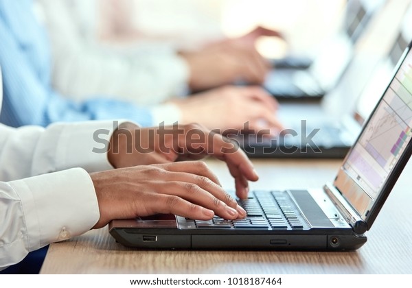 black person typing fingers laptop