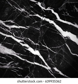 Black marble texture shot through with subtle white veining (Natural pattern for backdrop or background, Can also be used for create surface effect to architectural slab, ceramic floor and wall tiles)