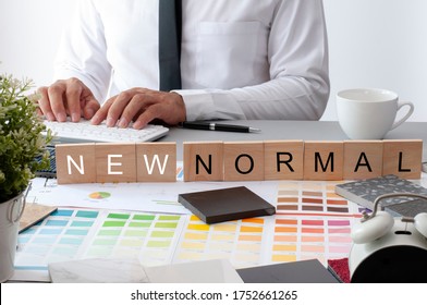 Black Marble Tile. Materials Construction On The Table. New Normal Text On The Work Table. Businessman Working In New Normal Space. Blur Asian Man . The New Mormal Text.