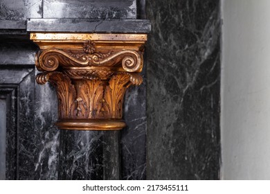 Black marble wall with golden pillar decoration. Classic luxury interior details. 