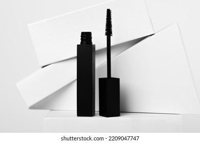 Black Mascara And Brush With Geometric Shapes On White Background. Luxury Cosmetic Product For Eyes Makeup. Beauty And Fashion Industry