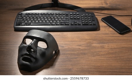 Black mask and computer on the table.