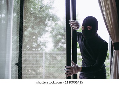 Black mask thief and window - Shutterstock ID 1110901415