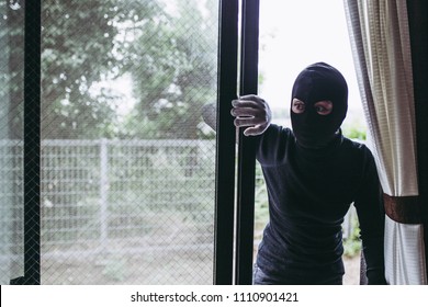 Black mask thief and window - Shutterstock ID 1110901421