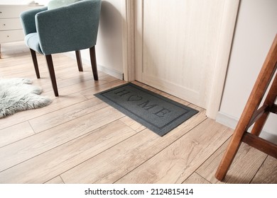 Black Mat Near Light Wooden Door In Modern Hall