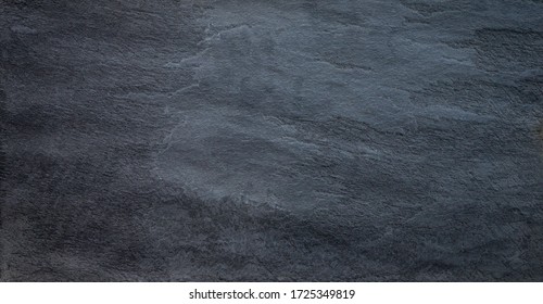 Black mat textured solid stone slab background.