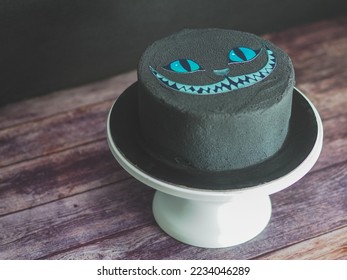 black matte edible paint on frosted spongy birthday cake with bad cat printed topper isolated on studio