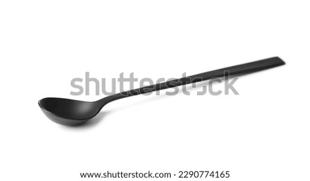 Black matte metal spoon with a long handle on a white background, coffee spoon, black cutlery on white isolated.