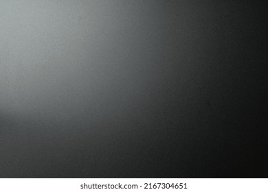 Black Matte Plastic Background With Texture And Lighting.