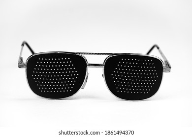            Black Medical Glasses With A Hole On A Light Background. Metal Frame. Glasses With Holes For Vision, Pinhole Glasses.                    