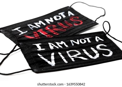 Black medical masks with the inscription "I am not a virus" on white background