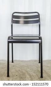 Black Metal Chair On Gray Wall