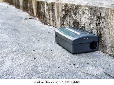 Black Metal External Rodent Rat Bait Station Outside Against A Wall Close Up.  Pest Control.