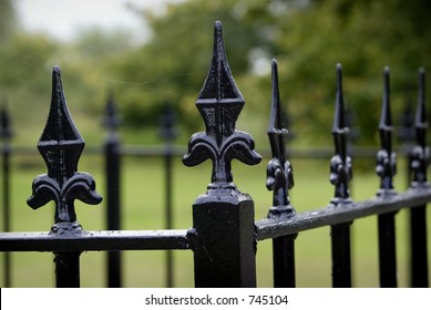 Black Metal Fencing With A Fleur De Lys Top