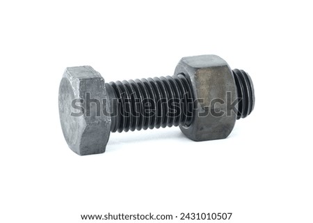 Black metal hexagonal bolt and nut shown in close-up isolated on white background