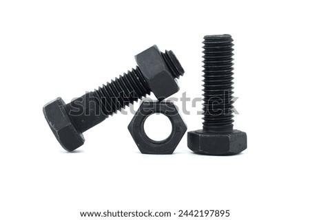 Black metal hexagonal bolts and nuts shown in close-up isolated on white background
