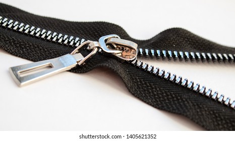 Black Metal Open Zipper Closeup Isolated On White Background Macro