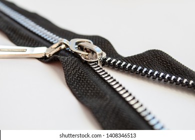 Black Metal Open Zipper Closeup Isolated On White Background Macro