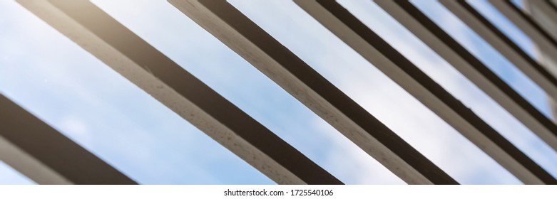 Black Metal Shutters Against Blue Sky With Clouds And Bright Sunlight Reflection Low Angle Shot Extreme Close View