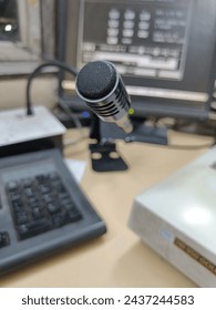 Black mic with background computer and keyboard in office 