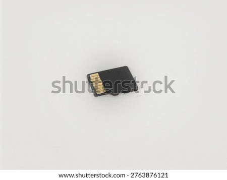 Black Micro SD memory card on a white background. Ideal for technology, electronics, and data storage themes 
