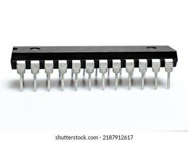 Black Microchip With Metal Legs On A White Background. Microcircuit, Silicon Chip. Macro Photo. Part Of A Computer Motherboard. 