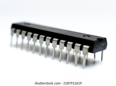 Black Microchip With Metal Legs On A White Background. Microcircuit, Silicon Chip. Macro Photo. Part Of A Computer Motherboard. 