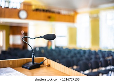 Black Microphone In An Empty Conference Hall, Empty Chair, Ready For Public Speaking