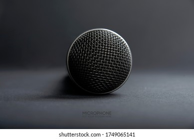 A Black microphone on dark shadow background for audio record or Podcast concept - music instrument concept - Shutterstock ID 1749065141