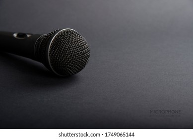 A Black microphone on dark shadow background for audio record or Podcast concept - music instrument concept - Shutterstock ID 1749065144