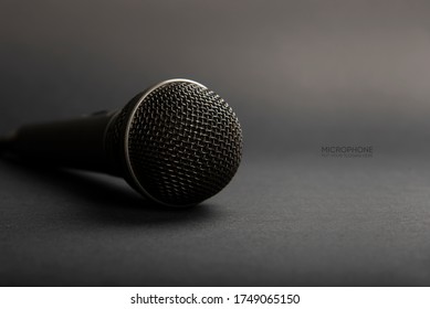 A Black microphone on dark shadow background for audio record or Podcast concept - music instrument concept - Shutterstock ID 1749065150
