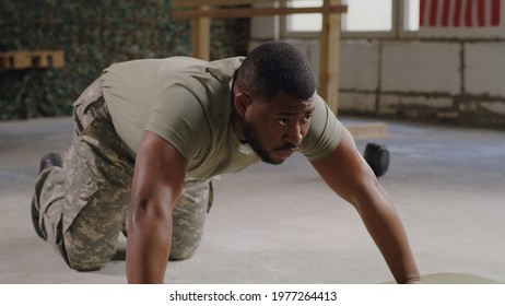 Black military man doing push ups in gym - Powered by Shutterstock