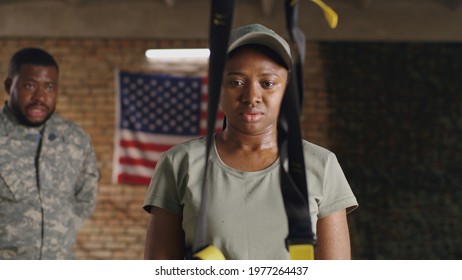 Black military woman listening to trainer and resting in gym - Powered by Shutterstock