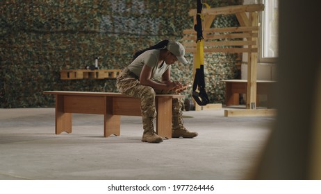 Black military woman using smartphone in gym - Powered by Shutterstock