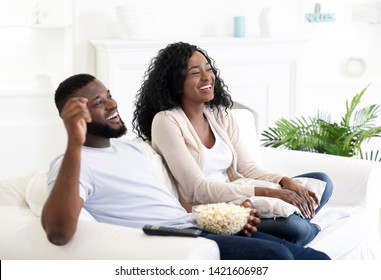 Black Millennial Couple Watching Tv, Sitting On Couch With Popcorn At Home, Free Space